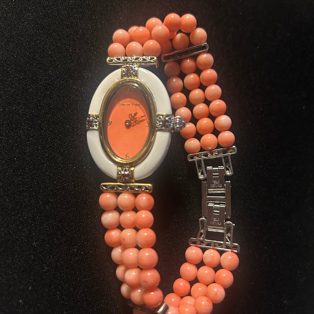 Silver 925 back  white accents,corals bracelet with small red stone .